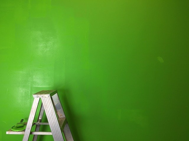 Ladder next to a green wall